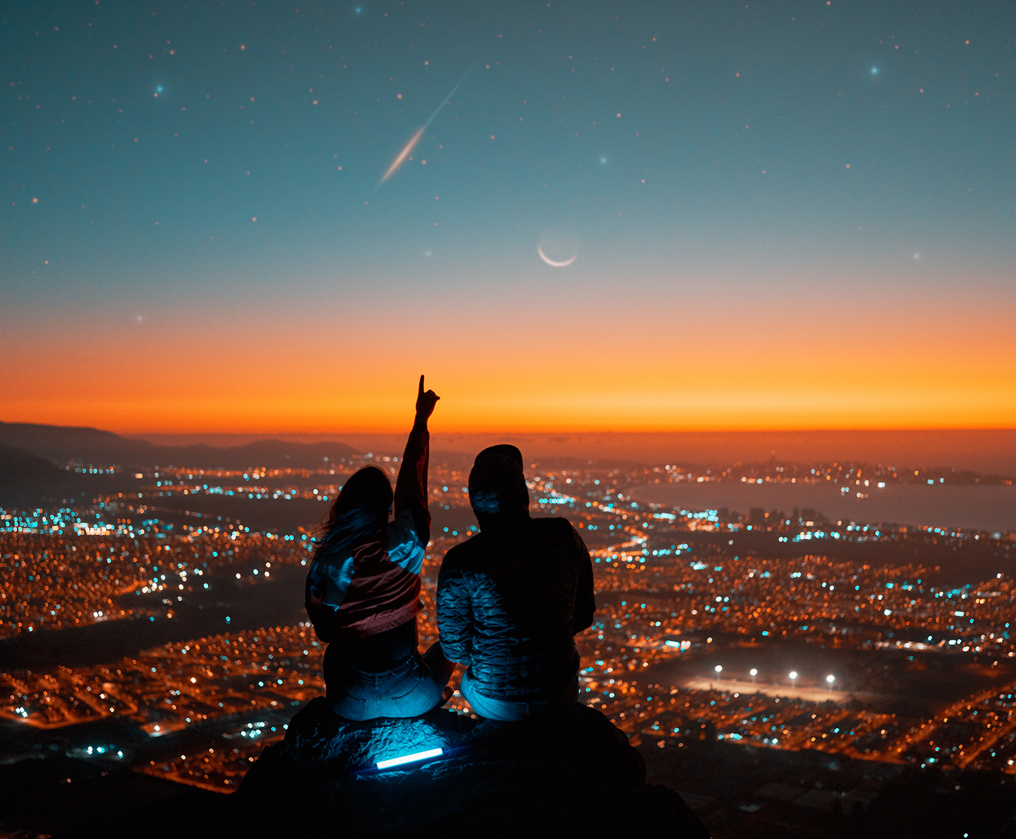 Two people looking at a shooting star